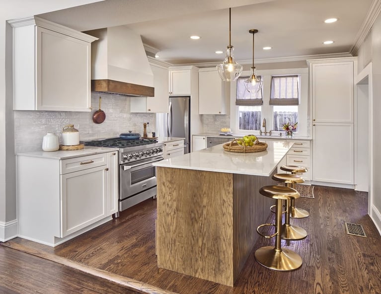 High-end kitchen remodel in Dallas, Texas with two pendant lights above island with gold bar stools